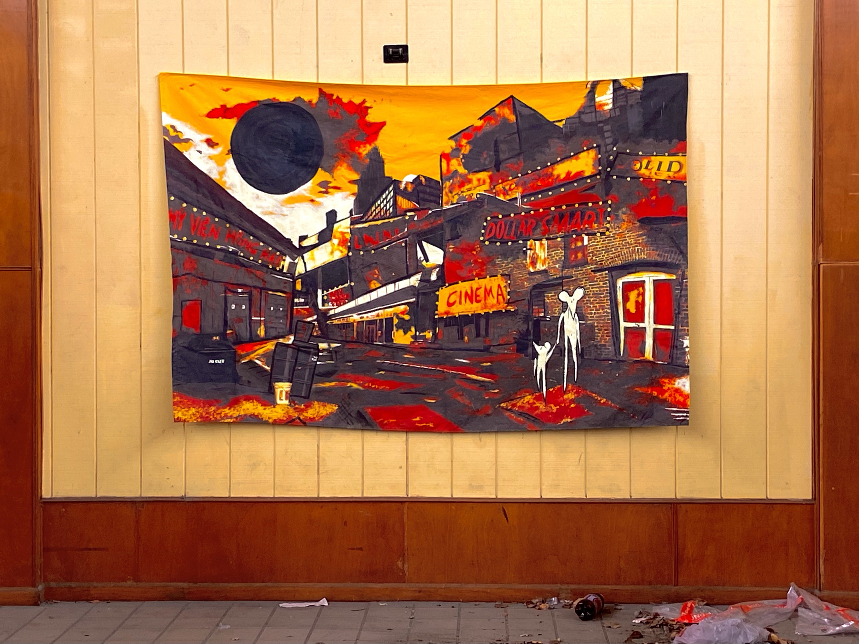 A painting of a hellish landscape hung on a wall